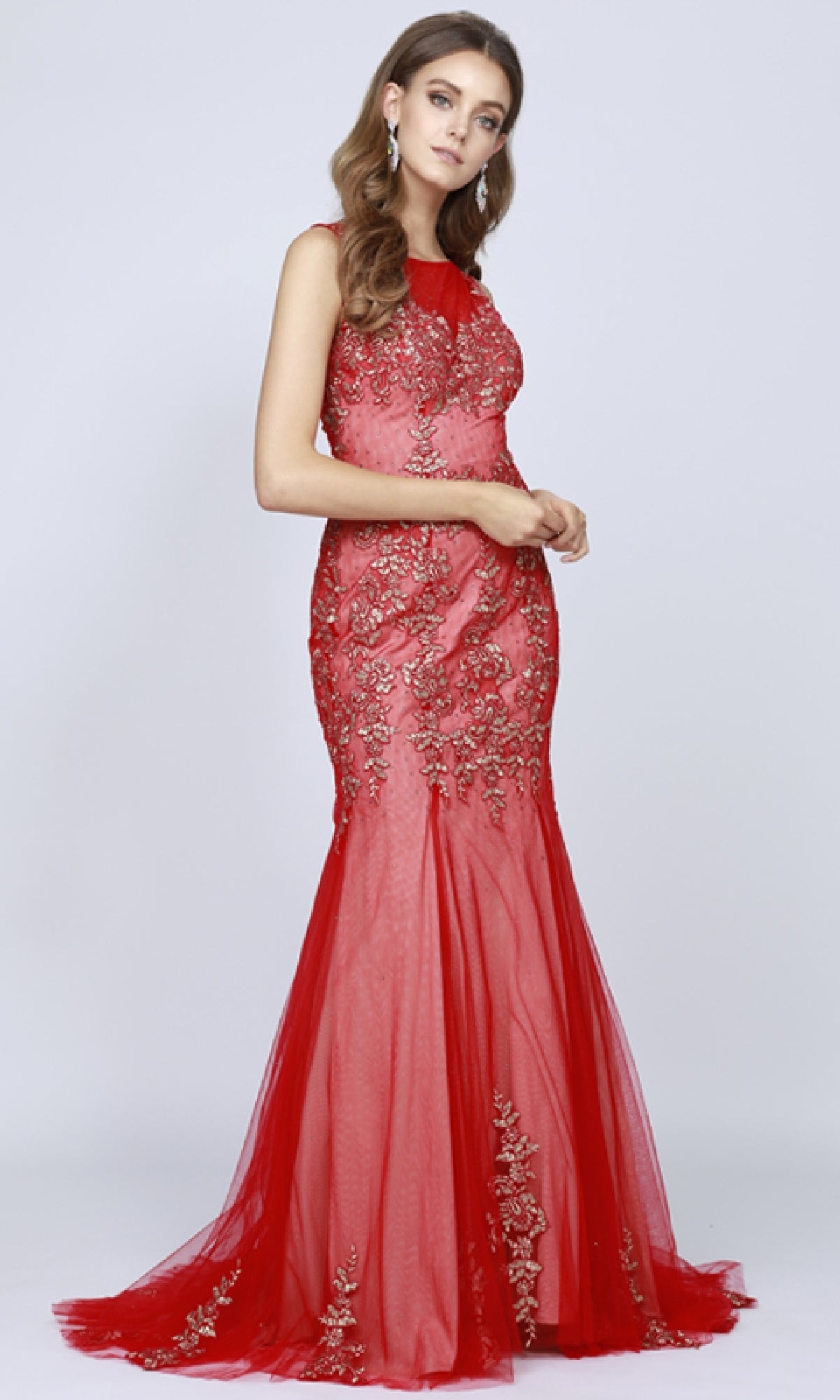 A woman models the Juliet 656 Long Prom Dress, a floor-length, sleeveless red gown with intricate gold embroidery, set against a plain light background.
